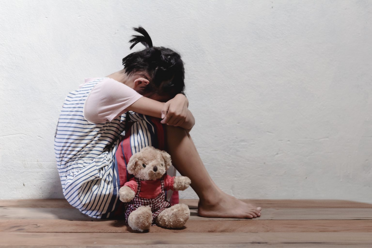 traumatized-children-concept-little-girl-sitting-at-the-corner-of-the